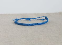 This listing is for one tiny cord bracelet, handmade by macramé, in blue. Perfect jewel for him or for her, comfortable, resistant, to add a boho, surf, modern touch to your outfit! Choose from variations the style you like the most: you can have the bracelet twisted or flat (see picture) You will recive this bracelet in a beautiful gift packaging ♥ - - - - - - - - - - - - - - - - - - - ▼ Width: approx 5 mm (0.2 inches) ▼ The bracelet has a sliding knot to adjust the length to the size you need. Blue Friendship Bracelet, Techniques Textiles, Reef Knot, Jewelry For Him, Surf Jewelry, Wax Cord Bracelet, Cord Bracelet, Sliding Knot, Cord Bracelets