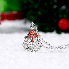 Our Santa Claus necklace is a great way to show your Christmas spirit and even if you don't catch a glimpse of Santa and his reindeer on Christmas eve you'll still have this amazing Christmas necklace to show how thankful you are for all the gifts he brings! The shimmering Santa pendant necklace sparkles with glittering white and red stones and will add some whimsy to your holiday outfit.Carat Weight: 1.989 ctStone Size: 1.1,1.4,1.6,1.6,1.4 mmStone Type: Jeulia® StoneNumber of Stones: 54 Stone S Elegant Christmas Holiday Jewelry, Festive Round Christmas Jewelry, Holiday Party Silver Necklaces, Holiday Party Silver Necklace, Red Jewelry Christmas Gift, Red Christmas Jewelry Gift, Silver Necklaces For Winter Holidays, Red Jewelry For Christmas Gift, Festive Red Christmas Necklaces