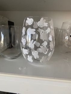 some glasses are sitting on a shelf next to each other