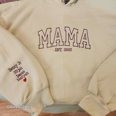 Mama Hoodie Personalized with kids names on the sleeve Gildan Hoodie 18500 8-ounce, 50/50 cotton/poly Double-needle stitching at waistband and cuffs Double-lined hood with dyed-to-match drawcord 1x1 rib knit cuffs and waistband with spandex Front pouch pocket CARE INSTRUCTIONS Machine wash warm, with like colors.  Do not bleach.  Tumble dry and Iron on the cotton setting. EXCHANGES & RETURNS I do not accept returns or exchanges on any items unless it is a mistake on our end. Exchanges are allowe Personalized Cotton Sweatshirt For Family, Personalized Cotton Family Sweatshirt, Mama Zip Up Hoodie, Personalized Cotton Sweatshirt With Name Print, Mama Sweatshirt With Names On Sleeve, Mama Hoodie, Gildan Hoodie, Knit Cuff, Kid Names