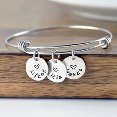 "Personalized Gift, Charm Bracelet, Name Bracelet, Gift for Her, Gift for Mom, Mothers Day Gift, Mom Gift, Mom Birthday, Kids Names This listing is for: one bangle bracelet premium stainless steel bangle this is one size fits all. and 1/2\" sterling silver name charms. ♥CONNECT WITH US♥ ✤pinterest.com/luckyhorngifts ✤facebook.com/luckyhorngifts ✤twitter.com/luckyhorngifts ✤instagram.com/luckyhorngifts" Handmade Round Charm Bracelet For Birthday, Adjustable Charm Bracelets For Birthday, Birthday Gift Bracelets With Charms, Nickel-free Charm Bracelet For Birthday And Mother's Day, Handmade Charm Bracelet For Birthday And Valentine's Day, Adjustable Name Bracelet With Charms For Birthday, Round Charms Bracelets For Birthday Gift, Charms Bracelets For Birthday Gift, Name Bracelet For Birthday And Mother's Day