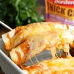 a close up of food in a pan on a table with sauce and seasoning