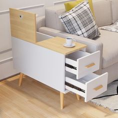 a coffee table with two drawers in front of a couch and rug on the floor