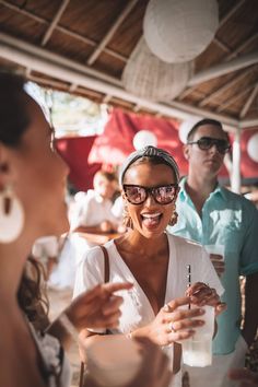 a woman laughing while standing next to other people