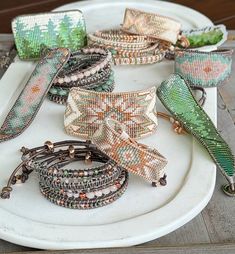 a white plate topped with lots of bracelets