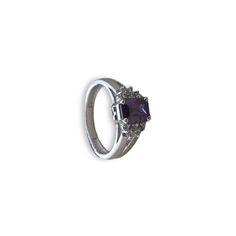 Elevate your style with our Amethyst CZ Sparkle Ring, meticulously crafted in silver and adorned with a stunning amethyst CZ stone for a luxurious and vibrant appearance. The ring also features unique 5A lab-created diamonds by CZ, adding to its high-quality and real diamond feel. Finished with 18kt gold plating and a highly-reflective rhodium polish, this ring not only dazzles but also ensures durability and prevents tarnishing. Finish: White Gold Plating Material: Silver, Alloy, CZ Stones, Ame Luxury Sterling Silver Amethyst Gemstone Ring, Luxury Amethyst Spiritual Rings, Luxury Collectible Amethyst Ring, Heart-shaped Sterling Silver Amethyst Ring Gift, Luxury Purple Crystal Ring, Fine Jewelry, Artificial Jewelry, Sparkling Rings, Amethyst Color, Jewelry Indian