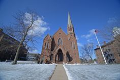 an old church with snow on the ground