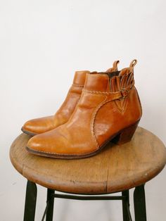 Vintage Brown Leather Western Ankle Boots. Made in Brazil.  Measurement  Tagged size              : 8D Length(heel to toe) : 10 1/2"  Height (without heel)  : 4 1/2" Heel                           : 2" Condition                 : Gently used. There's no stains or holes. Good condition. Leather Round Toe Booties For Rodeo, Western Brown Ankle-high Booties, Brown Western Style Booties Medium Width, Vintage Heeled Boots With Pointed Toe And Leather Sole, Vintage Ankle Boots With Stacked Heel, Vintage Heeled Boots With Leather Sole, Vintage High Heel Boots With Leather Sole, Vintage High Heeled Boots With Leather Sole, Vintage Snip Toe Heeled Boots With Reinforced Heel