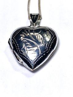 This is a sterling silver heart shaped picture locket. The locket is hinged and closes securely and tightly. The front and back are engraved with a leaf design.  The chain is sterling silver as well. . Shape Pictures, Picture Locket, Heart Pictures, Sterling Silver Heart, Silver Heart, Leaf Design, Pendant Necklaces, Locket, Selling On Etsy