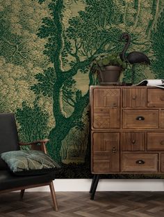 a room with a chair, dresser and wallpaper that has a bird on it