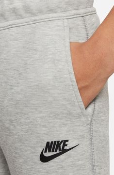 Lightweight Tech Fleece brings warmth without added bulk to kid-size joggers made with handy pockets and a vibe that's perfect for playing or relaxing. Drawstring waist Front zip pockets 52% cotton, 48% polyester Machine wash, dry flat Imported