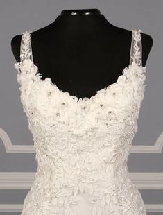 a white wedding dress on a mannequin with floral appliques and beading