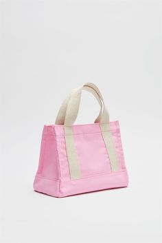 Introducing the Pink Women Canvas Mini Tote Bag from Lunarity Garage, a charming and versatile accessory that adds a playful touch to your everyday style. This mini tote bag features a delightful pink color, exuding femininity and vibrancy. Crafted with meticulous attention to detail, this mini tote bag combines fashion and functionality. The compact size makes it perfect for carrying your essentials on the go, while the durable canvas material ensures long-lasting use. The pink color adds a che Trendy Pink Satchel Canvas Bag, Casual Pink Top Handle Shoulder Bag, Casual Pink Top Handle Bag, Pink Tote Bag With Top Carry Handle, Pink Pouch Bag With Top Carry Handle, Trendy Pink Canvas Shoulder Bag, Trendy Pink Shoulder Canvas Bag, Summer Pink Top Handle Bag, Pink Top Handle Bag For Summer