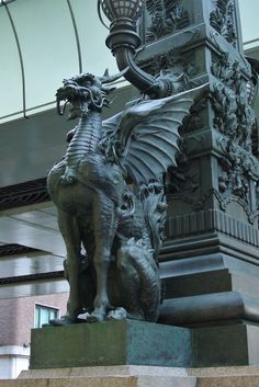 a statue of a dragon on top of a pillar