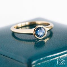 Minimal and modern, this bezel engagement ring features a natural, 5mm Montana sapphire set in a round tapering round bezel. Adhering to its modern and minimal character, the tapered bezel setting merges seamlessly into the ring's shank. The width of the band measures between 2.25mm to 3mm wide along its length, while its cross sectional thickness measures about 2.3mm along the bottom and sides. The height from the stone's table to the top of finger measures about 4mm to ensure a low and sleek profile, while the inner band is of 'comfort fit' design thus making this ring very comfortable for everyday wear.  The ring shown in the picture has a polished mirror finish but I'll be happy to provide a brushed matte finish upon request. All jewelry is designed and hand made by me in my studio her Modern Sapphire Ring, Sapphire Bezel Ring, Minimal Character, Engagement Ring Modern, Montana Sapphires, Engagement Ring Blue, Traditional Rings, Rings Boho, Bezel Set Engagement Ring