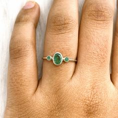 This Ring comes with a 100% Natural Green Emerald Gemstone and it is made up of 925 solid sterling silver. This ring is handcrafted by our skilled craftsmen and designed by us. Every gemstone is handpicked for the best quality.  Materials:- Silver (925 Solid Sterling Silver) Item Weight :- approx. 2 Grams Gemstone:- Natural Green Emerald Stone Size :- 6x4 MM  Stone Shape :- Oval Cut Secondary Stone & Size :- Green Emerald, 2MM Round Select Size in Variation, if you don't find perfect size please Minimalist Oval Emerald Ring With Bezel Setting, Adjustable Oval Emerald Rings, Oval May Birthstone Rings For Everyday, Dainty Oval Stackable Birthstone Ring, Dainty Oval Birthstone Ring For Everyday, Adjustable Dainty Oval Birthstone Ring, Minimalist Oval May Birthstone Rings, Sterling Silver Open Emerald Ring As Birthstone, Fine Jewelry Stackable Oval Rings