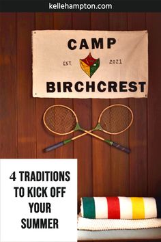 two tennis racquets are hanging on the wall next to a sign that says camp birchcrest