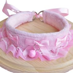 a pink headband with bows and pearls