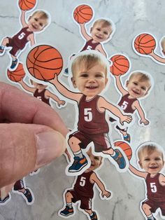 a person holding up a sticker with basketballs on it