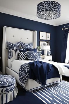 a bedroom with blue walls and white furniture