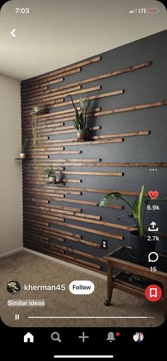 an image of a room with wooden slats on the wall and plants in pots