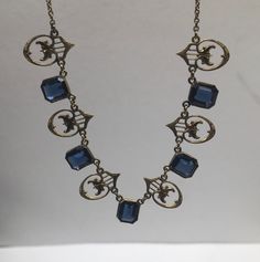 "Beautiful antique victorian Art Deco gold filled with royal blue sapphire necklace cute and dainty good pre-owned condition measures 16\" length." Antique Sapphire Necklace, Formal Hallmarked Blue Necklaces, Formal Blue Hallmarked Necklaces, Formal Blue Hallmarked Necklace, Blue Brass Jewelry With Vintage Charm, Victorian Style Hallmarked Sapphire Jewelry, Antique Blue Brass Jewelry, Vintage Sapphire Jewelry For Formal Occasions, Antique Gold Vintage Charm Necklace For Formal Occasions