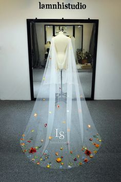 a wedding veil with flowers on the bottom