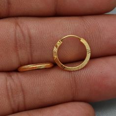 20kt 20 karat small hoop cartilage yellow gold Hoop Bali earrings  Gold Purity- 20k yellow Gold Weight - 0.98 grams approx Full Length - 1.3 cm approx Full Width - 1.3 cm approx click to see similar  https://www.etsy.com/in-en/shop/morvijewels?ref=seller-platform-mcnav Click here  https://morvijewels.etsy.com/    to get more discount and offers Happy to take wholesale bulk orders. Gold Hoop Cartilage Earrings For Anniversary, Dainty Yellow Gold Hoop Earrings Gift, Small Hoop Gold Cartilage Earrings As Gift, Gold-plated Round Cartilage Earrings, Hoop Nose Rings For Anniversary, Gold Small Hoop Nose Rings For Anniversary, Gold Huggie Cartilage Earrings As Gift, Gold Huggie Cartilage Earrings For Wedding, Single Yellow Gold Hoop Earring As A Gift