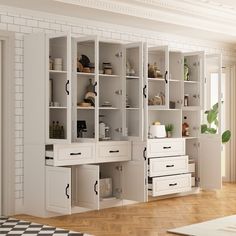 an empty room with white cabinets and drawers