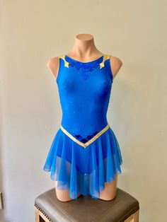 a blue leotard dress sitting on top of a stool