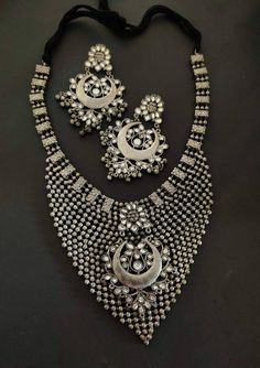 Add style and charisma to your beautiful personality with this exquisitely designed and handcrafted high quality silver look alike necklace set .Pair it up with any casual, semi formal or, formal attire and gather compliments for your unique and classy choice. Ideal wear for both casual and dressy occasions Necklace length 24 inches with an adjustable black dori at the back Weight 180 GM's Each earring weighs 20 GM's ( earrings are light weight and comfortable to wear) Length 3.5 inches Note: Al Silver Kundan Necklace With Intricate Design, Bohemian Silver Jewelry Sets With Stone Work, Traditional Oxidized Finish Necklace For Party, Handmade Silver Kundan Necklace, Handmade Elegant Silver Kundan Necklace, Elegant Handmade Silver Kundan Necklace, Traditional Hand Set Kundan Necklace, Traditional Sterling Silver Necklaces For Party, Silver Metal Bridal Necklace In Temple Jewelry Style