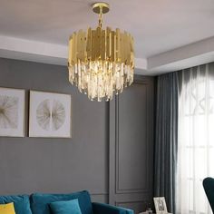 a living room filled with furniture and a gold chandelier hanging from the ceiling