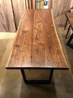 a wooden table sitting on top of a cement floor