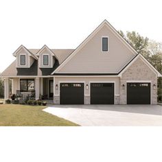 a large white house with two garages