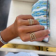 a woman's hand with two rings on it