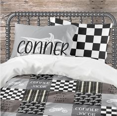 a black and white checkered comforter set on a bed with two pillow cases