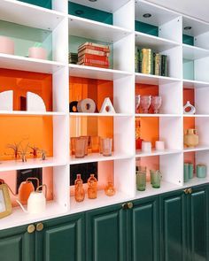 the shelves are filled with different colored vases and other decorative items, including bookshelves