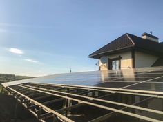 solar panels on the roof of a house with blue sky in the backgroud