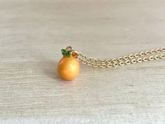 This dainty orange / tangerine necklace is made of the following: (1) Gold plated orange slice charm (charm size: 12 x 8.5mm) (2) Gold plated or 14KGF chain and findings ✏️ Please choose the length of the chain (the length includes clasp and findings) ✏️ Please choose your desired plating of chain ❣️ If you are unsure about which length to choose , please leave me a note to request an extension chain to be added to the chain at check out. 🍊EARRINGS 🍊 Threader -> https://www.etsy.com/listing Orange Pendant Charm Necklaces For Gifts, Handmade Orange Charm Necklace As A Gift, Handmade Orange Charm Necklace For Gift, Orange Necklace With Adjustable Chain For Gift, Orange Necklace With Adjustable Chain As Gift, Orange Dainty Jewelry For Gifts, Dainty Orange Jewelry For Gifts, Dainty Orange Jewelry For Gift, Daruma Doll