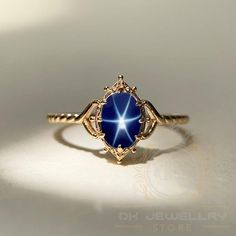 14k Yellow Gold Blue Star Sapphire Ring - Lindy Star Gemstone Jewelry, Perfect Gift for Her ★ Settings ☆ Metal - 925K Sterling Silver ☆ band Color - Rose / White / Yellow ⍟ The ring size shown in the pictures is 8 US. ★ Main Stone ☆ Stone - Lab Created blue star sapphire ☆ Size - 6×8 mm ☆ Shape - Oval ☆ Color Grade- AAA ☆ Certificate of Authenticity and lifetime warranty by Dkjewelrystore ★ Features : ☆ Handmade & Made to order. ☆ Ready to ship in 2-3 Business days. ☆ Complimentary gift wrapping Dark Blue Gemstone Ring, Midnight Blue Star Ring, Sapphire Ring Aesthetic, Fine Jewelry Star-shaped Gemstone, Star Shaped Sapphire Jewelry Gift, Celestial Star-shaped Gemstone Jewelry, Star-shaped Gemstone Fine Jewelry, Fine Jewelry Star Shaped Gemstone, Star Shaped Gemstone Fine Jewelry