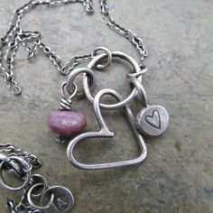 Silver Heart Charm Necklace Cluster Pink Ruby Gemstone Necklace Mother's Day Gift Love Jewelry: A cluster of my original handmade sterling silver charms is suspended from a delicate sterling chain that is approximately 17 1/2 inches in length. Included is a hand constructed wire heart, a round stamped heart and faceted pink Ruby nugget. Perfect for Mother's Day or any day! 100% hand made by me in my little home studio. Enter my shop: https://www.etsy.com/shop/artdi Join me on Facebook: https://www.facebook.com/Artdi-Diana-Anton-Jewelry-Design-44805607932/ Find me on Instagram: https://www.instagram.com/dianaantonjewelrydesign/ Handmade Heart Charm Necklace For Everyday, Sterling Silver Heart Beads Dangle Jewelry, Handmade Sterling Silver Dangle Charm Necklaces, Handmade Sterling Silver Dangle Charm Necklace, Handmade Heart Pendant Necklace For Everyday, Sterling Silver Charm Necklaces With Heart Beads For Gift, Sterling Silver Charm Necklace With Heart Beads For Gift, Handmade Silver Heart Charm Necklace, Sterling Silver Dangle Jewelry With Heart Charm