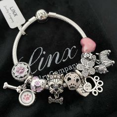 Linx Snake Chain Style Charm Bracelet With A Ball Clasp, Featuring Linx Logo. The Bracelet Comes With 7 Linx Charms As Shown. *All Items Are 925 Sterling Silver. *Guaranteed Authentic. *Linx Bracelets And Charms Are Very Well Made And Of Superior Quality, Designed To Last. These Pieces Come With A 100% Satisfaction Guarantee Or Your Money Back. *The Bracelet Is Available In Multiple Sizes *Additional Charms Can Also Be Added To The Bracelet And The Ones Included Are Removable As Well. *Linx Brac Silver Stainless Steel Snake Chain Jewelry, Silver Metal Box Chain Bracelet, White Gold Metal Bangle Charm Bracelet, Silver Charm Bracelet With Box Chain, Silver Box Chain Charm Bracelet, Nickel-free Silver Snake Chain Jewelry, Silver Snake Chain Bracelet For Gift, Silver Snake Chain Bracelet As Gift, Stainless Steel Charm Bracelet With Silver Chain As Gift