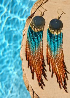 ♀️ Handmade seed bead earrings created with glass beads, brass, and sterling silver ear wires. ♀️ Beads: Czech, Toho ♀️ Ear Wire: Sterling silver ♀️ Drop Height: 6 in. ♀️ Thread: Nylon ♀️ Nickel free ♀️ Care instructions: To maintain earrings's brightness, please do not shower, swim, or workout with them Gold Heishi Beads Earrings, Gold Heishi Bead Earrings With Colorful Beads, Gold Heishi Beaded Earrings With Colorful Beads, Summer Festival Beaded Fringe Earrings, Bohemian Multicolor Beaded Earrings In Czech Glass, Bohemian Multicolor Czech Glass Beaded Earrings, Gold Beaded Fringe Earrings For Beach, Gold Beaded Fringe Earrings For Summer, Summer Beaded Earrings With Fringe And Round Beads