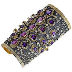 This rare bracelet is handmade from solid 18 Karat Yellow Gold and is decorated with the use of a microscope for precise detail. The decorations are all set individually one by one from 22 Karat solid yellow gold - granulation workmanship. The gorgeous one of a kind bracelet has a unique velvet look on the background and is finished with Black Rhodium. This stunning piece of art is heavily decorated with Oval shaped Amethysts of the same color and origin total weight of 176.0 Carat and Brilliant Yellow Gold Cuff Bracelet, Contemporary Bracelets, Vintage Cuff Bracelet, Diamond Cuff Bracelet, Gold Cuff Bracelet, Antique Bracelets, Gold Bracelet Cuff, Gold Cuffs, Diamond Gold