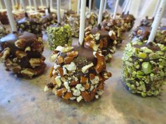 chocolate covered candies with nuts and almonds on them sitting on a counter top