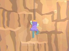 a toy is hanging from a rope on a wall in the desert, with rocks and sand behind it