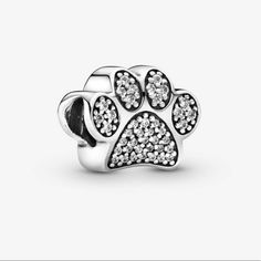 Brand New Sparkling Paw Print Charm Pandora Ale S925 Celebrate Your Favorite Four-Legged Friend With This Pandora Paw Print Charm. Finely Crafted In Sterling Silver, This Adorable Charm Is Embellished With Sparkling Cubic Zirconia Stones. A Delightful Gift For Any Cat Or Dog Lover, It Will Add Whimsical Charm To Your Pandora Jewelery Collection. Pandora Cat Charm, Pandora Dog Charm, Branded Gift Bags, Paw Pad, Pandora Flower, Cupcake Charms, Pandora Jewelry Charms, Pandora Pink, Paw Print Charm