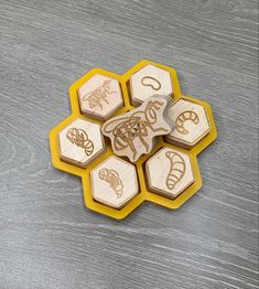 four wooden stamps sitting on top of each other in the shape of hexagons