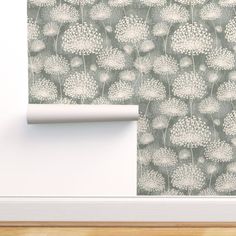 a wallpaper with white flowers on it next to a door