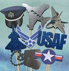 an assortment of air force cupcake toppers and cake picks on a blue background